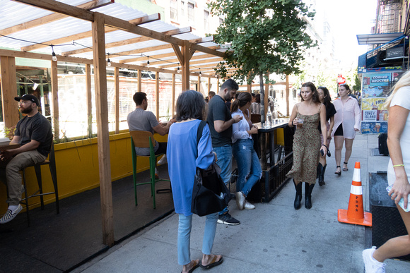 sheds and diners squeeze pedestrians into a narrow passageway.